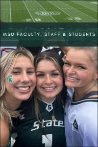 3 Spartan students at the stadium taking a group shot with the field behind them