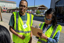 Volunteers in yellow vests doing a survey for Flint ReCAST