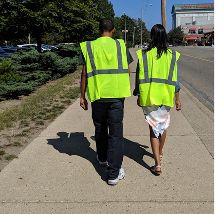 Volunteers walking in yellow vests to conduct surveys